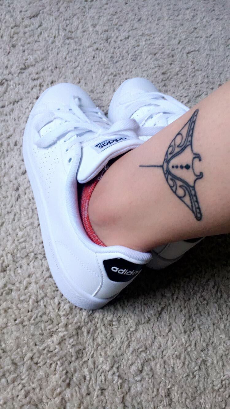 manta ray tattoo on ankle with white adidas shoes