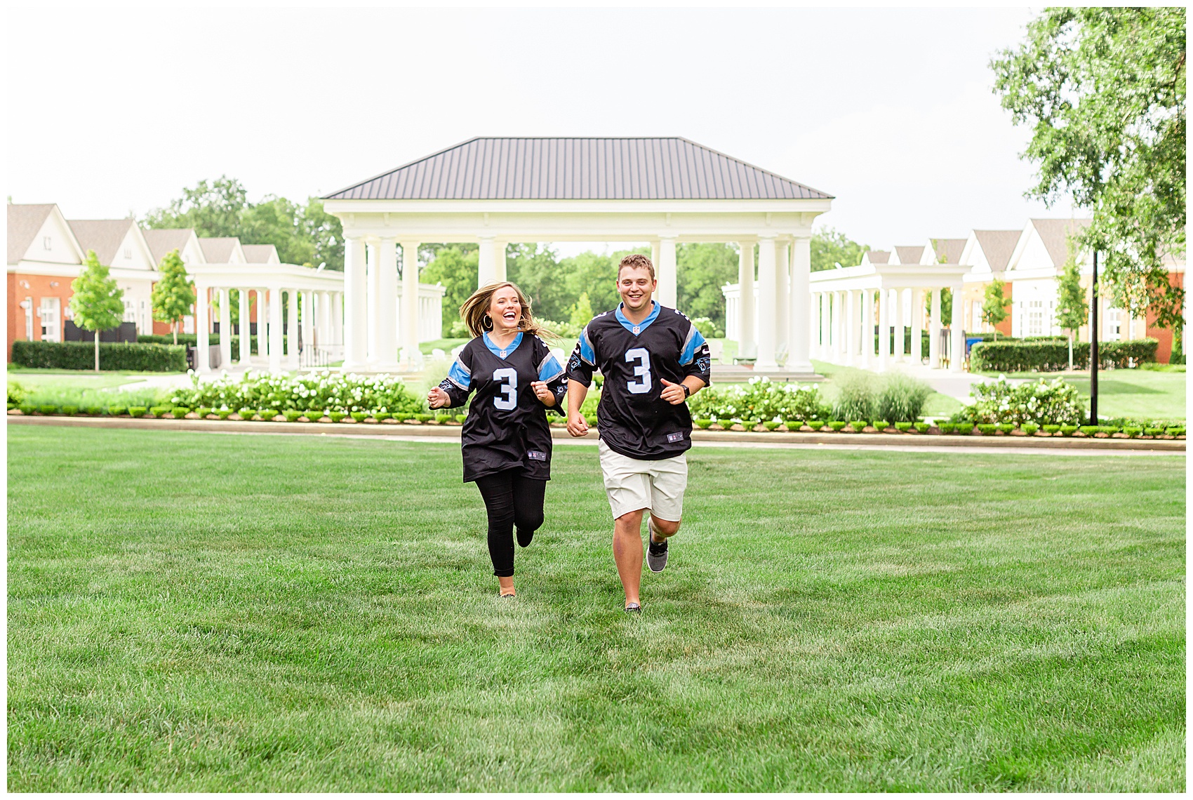 couple running in football jerseys for their engagement photos