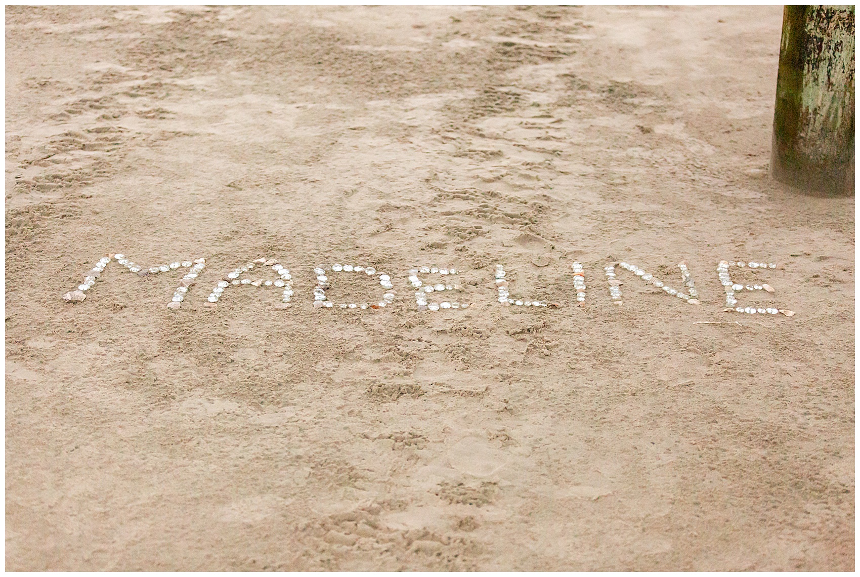 Name written on the sand for a proposal at folly beach, sc
