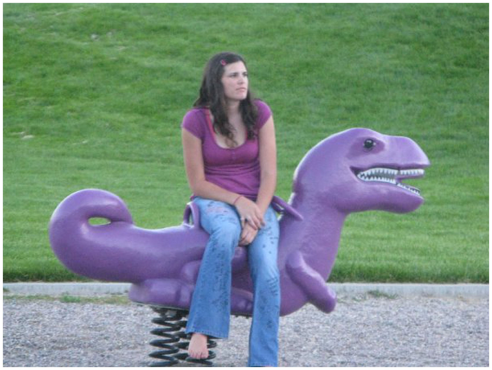 girl sitting on a purple dinosaur